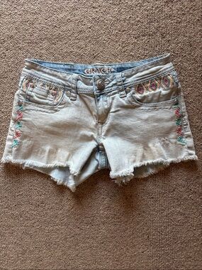 Grace in LA light blue denim shorts with colorful embroidery